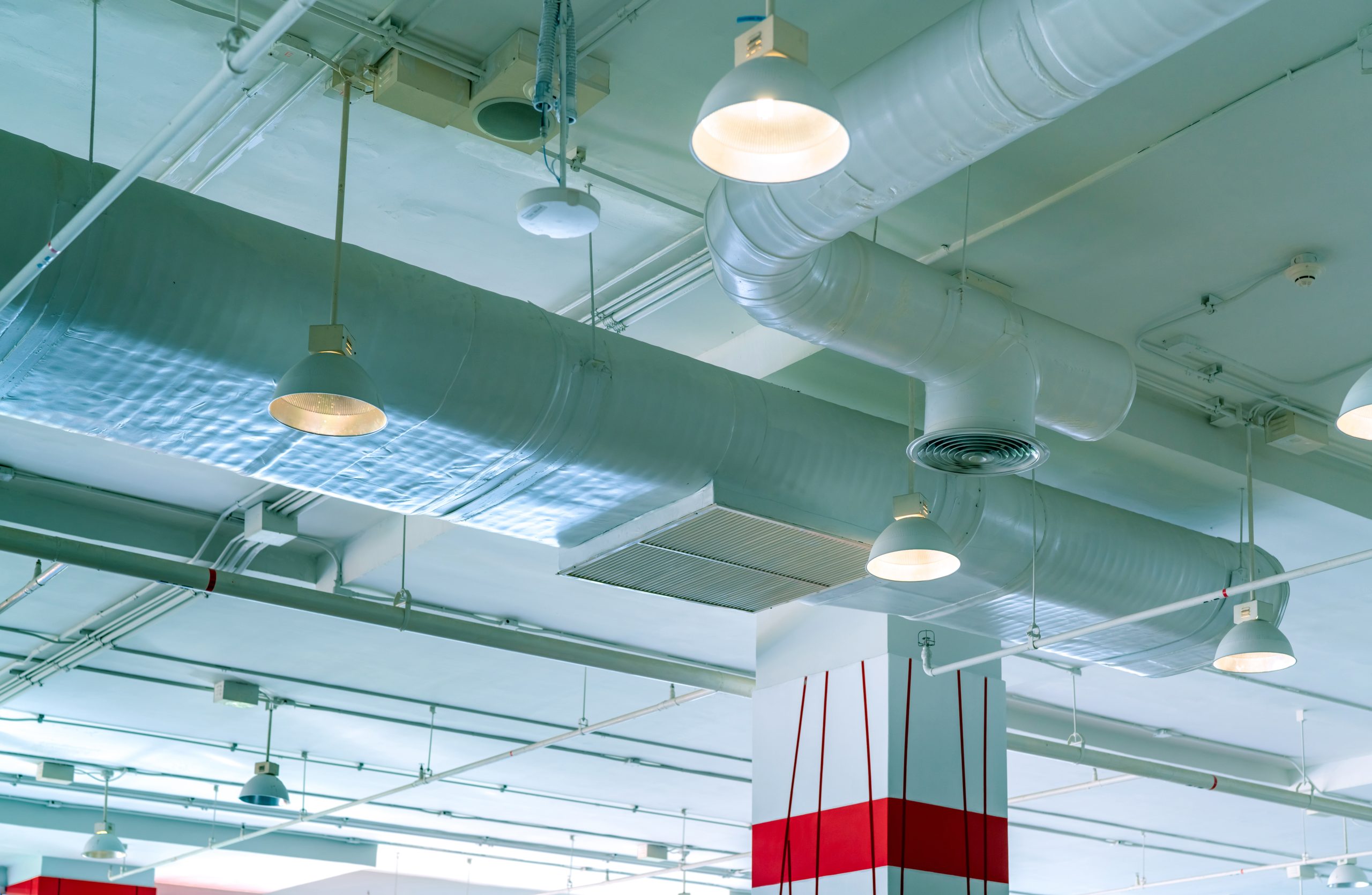 Air duct, air ventilation system in shopping mall building. Air conditioner pipe and plumbing pipe . Ceiling lamp light with opened light. Building interior concept. Interior architecture concept.